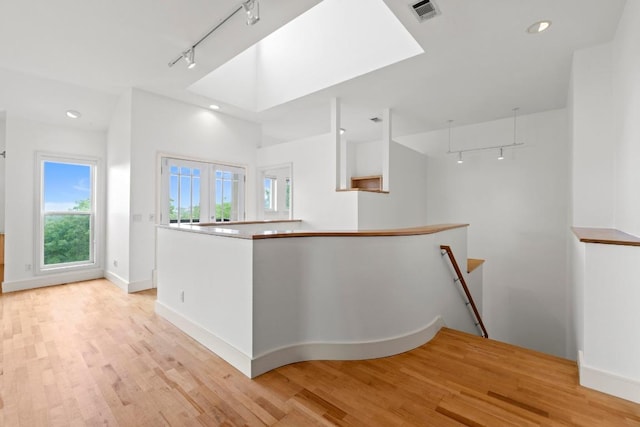 3800 Laurel Ledge Ln, Austin, TX 78731 - corridor with rail lighting, an upstairs landing, light wood finished floors, baseboards, and recessed lighting
