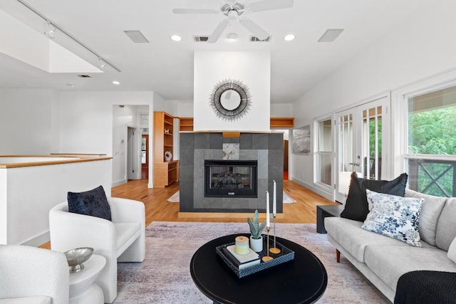 3800 Laurel Ledge Ln, Austin, TX 78731 - living room with wood finished floors, a tile fireplace, recessed lighting, ceiling fan, and french doors