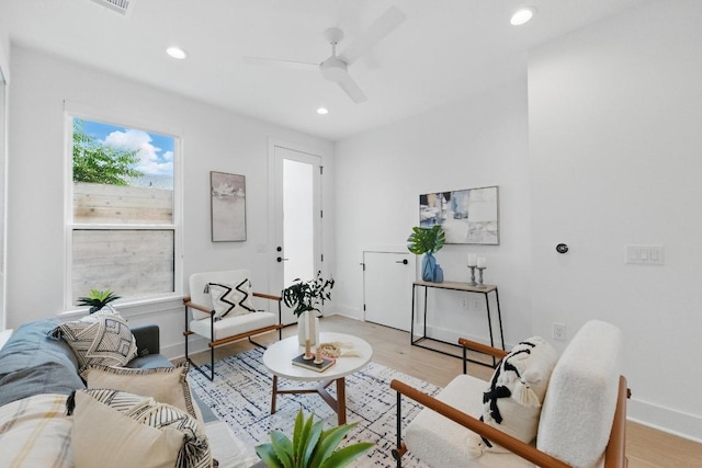 living area with recessed lighting, a ceiling fan, baseboards, and light wood-style floors