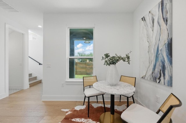living area featuring visible vents, wood finished floors, stairway, baseboards, and recessed lighting