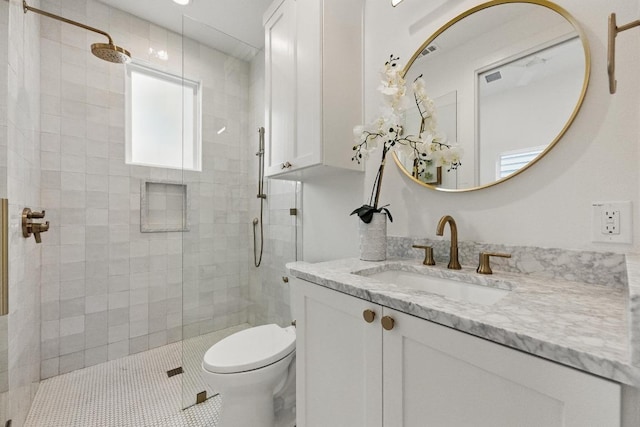 full bath with vanity, tile patterned floors, toilet, and a shower stall