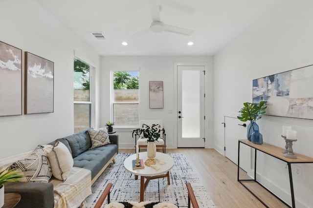 living room with ceiling fan, visible vents, baseboards, light wood-style floors, and recessed lighting