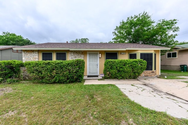 7103 Howerington Cir, Austin, TX 78724 - view of front of home featuring stone siding, a front lawn, and a shingled roof