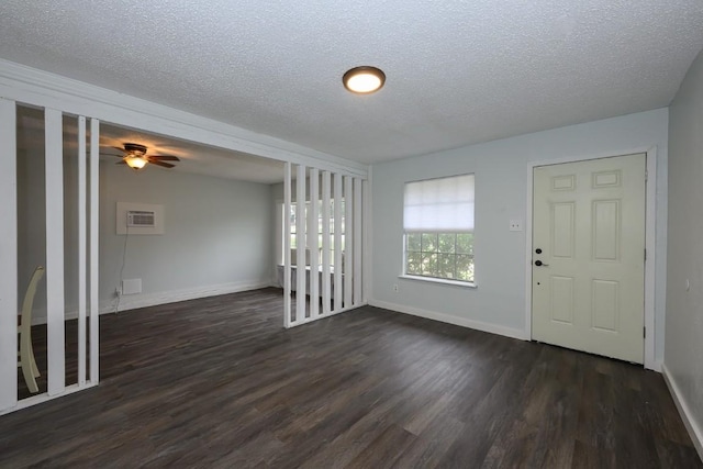 7103 Howerington Cir, Austin, TX 78724 - entryway featuring dark wood-style flooring, a textured ceiling, baseboards, ceiling fan, and a wall mounted AC