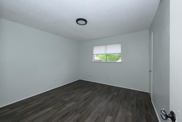7103 Howerington Cir, Austin, TX 78724 - spare room with dark wood-style floors, a textured ceiling, and baseboards