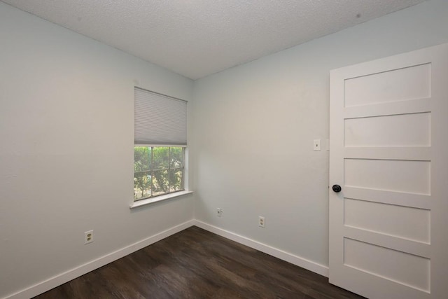 7103 Howerington Cir, Austin, TX 78724 - spare room featuring dark wood finished floors, baseboards, and a textured ceiling
