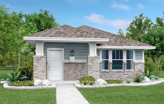 view of front of property featuring brick siding, roof with shingles, and a front yard