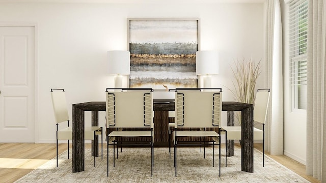 dining area featuring baseboards and wood finished floors