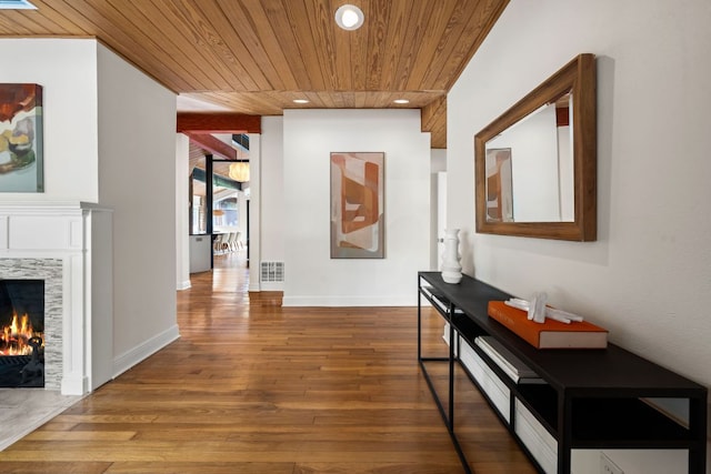 corridor featuring visible vents, wood-type flooring, baseboards, recessed lighting, and wood ceiling