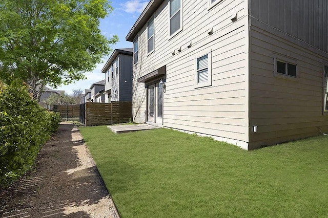 view of property exterior featuring fence and a yard