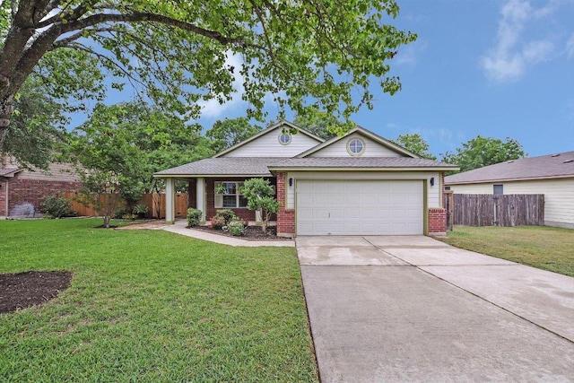 single story home featuring fence, a front yard, driveway, and brick siding