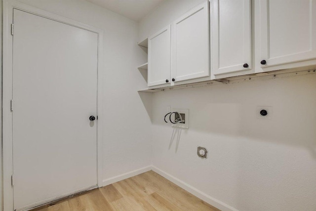 laundry room featuring hookup for an electric dryer, cabinet space, baseboards, light wood finished floors, and hookup for a washing machine