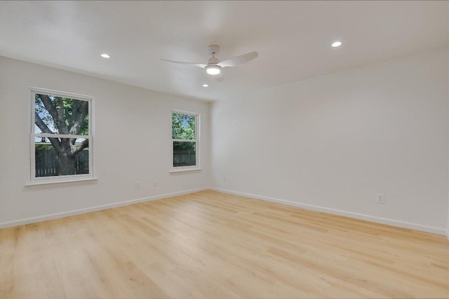empty room with recessed lighting, plenty of natural light, and light wood-style floors