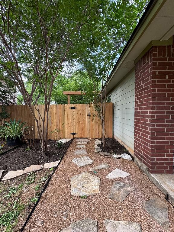 view of yard featuring fence and a gate