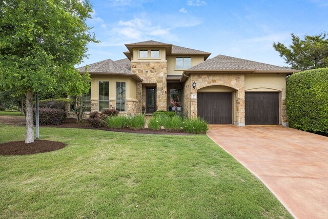 103 Maddy Way, Austin, TX 78738 - view of front facade with stucco siding, stone siding, a garage, driveway, and a front lawn