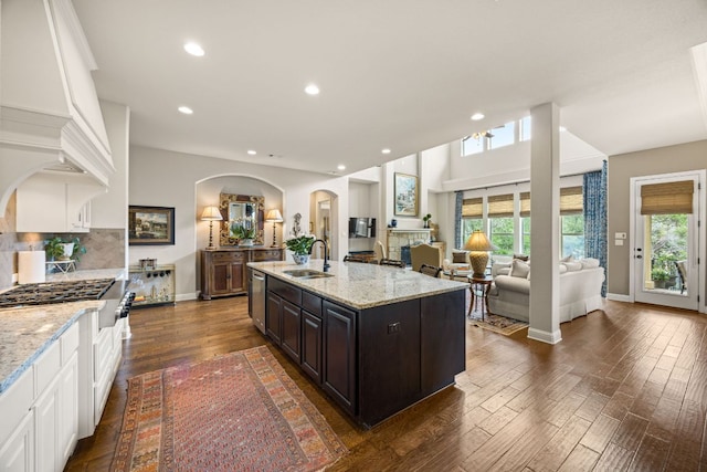 103 Maddy Way, Austin, TX 78738 - kitchen featuring arched walkways, healthy amount of natural light, white cabinetry, light stone counters, and recessed lighting