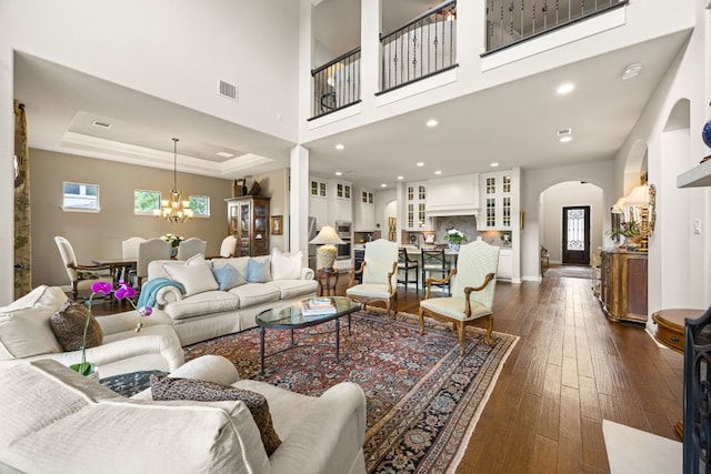103 Maddy Way, Austin, TX 78738 - living area featuring arched walkways, a chandelier, plenty of natural light, dark wood-style floors, and recessed lighting