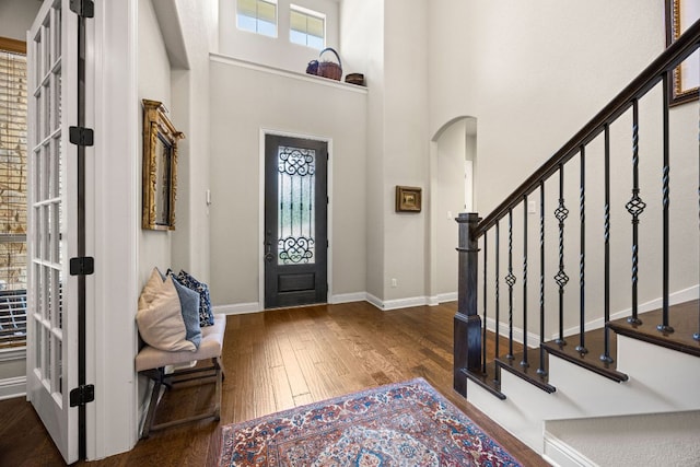 103 Maddy Way, Austin, TX 78738 - foyer entrance featuring wood-type flooring, arched walkways, stairs, and a high ceiling