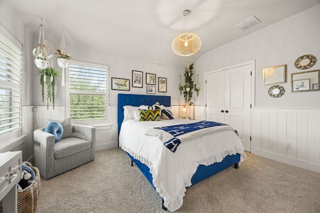 103 Maddy Way, Austin, TX 78738 - carpeted bedroom featuring a wainscoted wall, a closet, vaulted ceiling, and a decorative wall