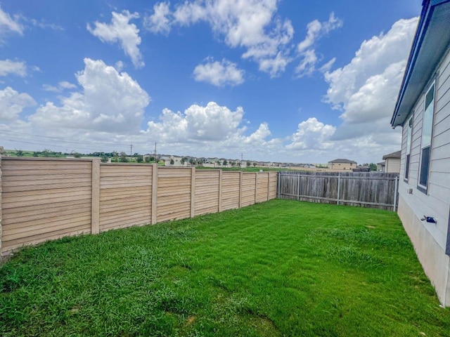 view of yard with a fenced backyard