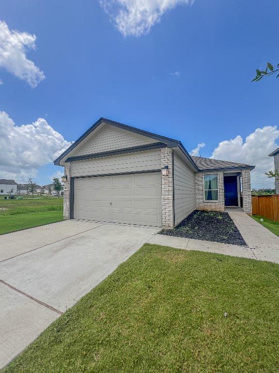 ranch-style house featuring brick siding, fence, a front lawn, concrete driveway, and an attached garage