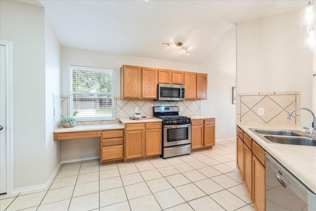 118 San Gabriel Dr, Kyle, TX 78640 - kitchen with a sink, stainless steel appliances, light tile patterned flooring, backsplash, and light countertops