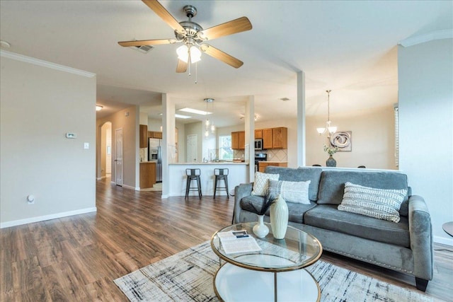 118 San Gabriel Dr, Kyle, TX 78640 - living area featuring baseboards, wood finished floors, a ceiling fan, and ornamental molding