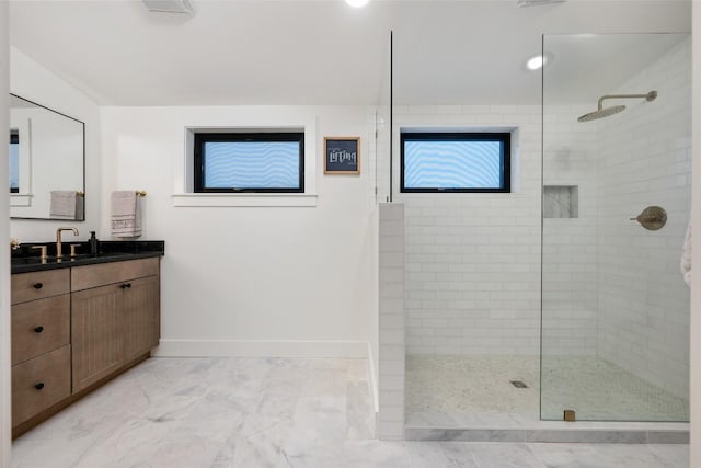 full bath featuring a walk in shower, baseboards, marble finish floor, and vanity