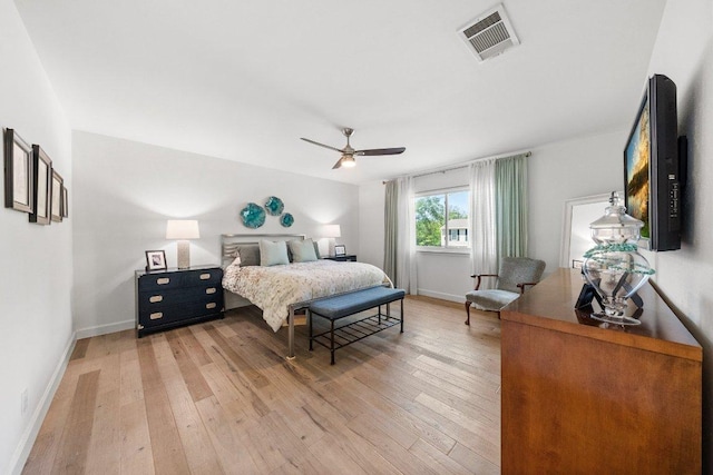 bedroom featuring visible vents, light wood-style flooring, ceiling fan, and baseboards