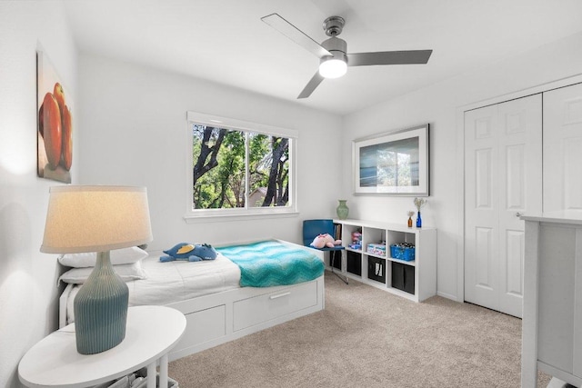 bedroom with a closet, a ceiling fan, and carpet