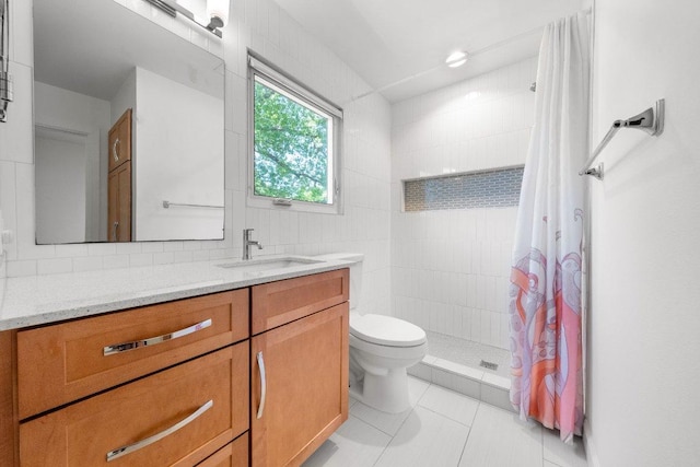 bathroom with vanity, toilet, tile patterned floors, tasteful backsplash, and tiled shower