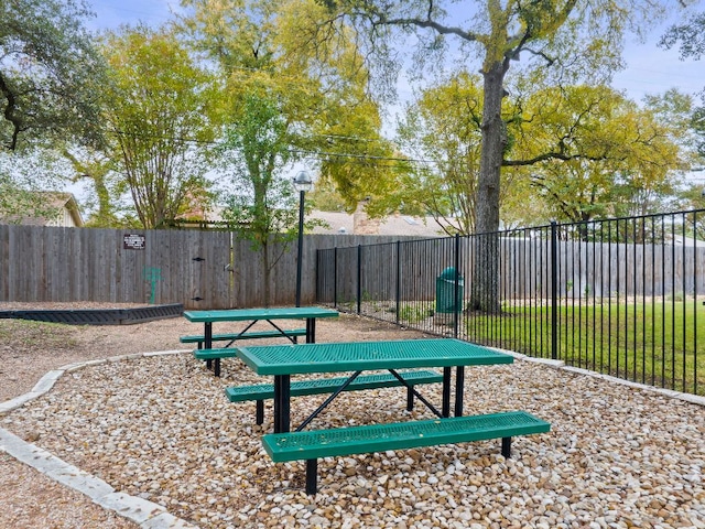 view of community featuring fence