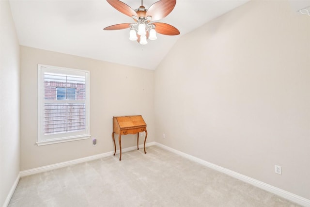 empty room with baseboards, ceiling fan, lofted ceiling, and light carpet