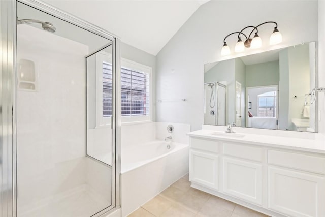 ensuite bathroom with a garden tub, a shower stall, vanity, tile patterned floors, and lofted ceiling