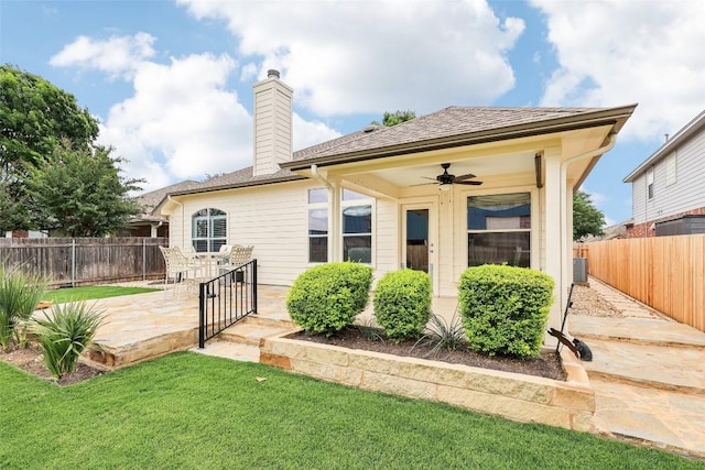 rear view of property featuring a fenced backyard, a patio, ceiling fan, and a yard