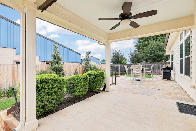 view of patio with a fenced backyard, a ceiling fan, outdoor dining space, and area for grilling