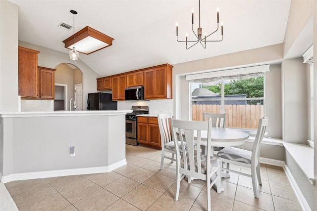 330 Wildhorse Crk, Buda, TX 78610 - dining room featuring a chandelier, light tile patterned floors, lofted ceiling, arched walkways, and baseboards