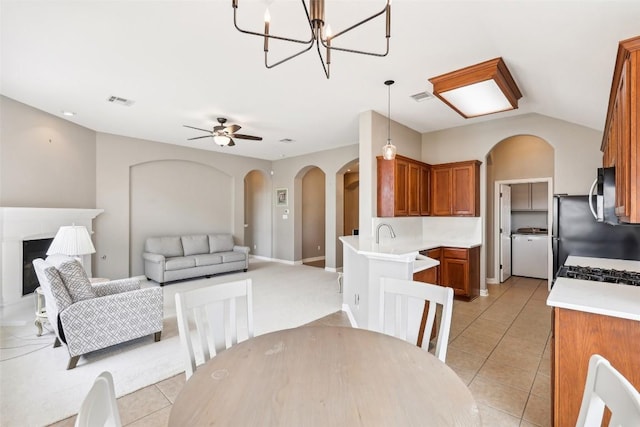 330 Wildhorse Crk, Buda, TX 78610 - dining area with arched walkways, light tile patterned floors, a chandelier, and ceiling fan