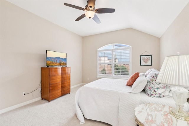 bedroom with baseboards, light colored carpet, ceiling fan, and vaulted ceiling