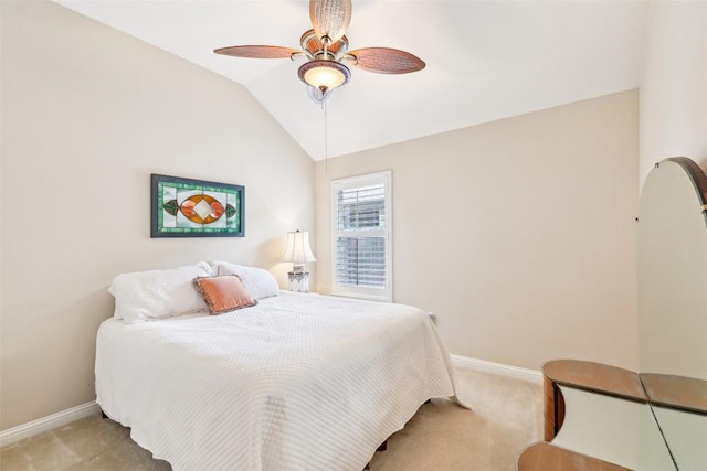 bedroom with light colored carpet, baseboards, and ceiling fan