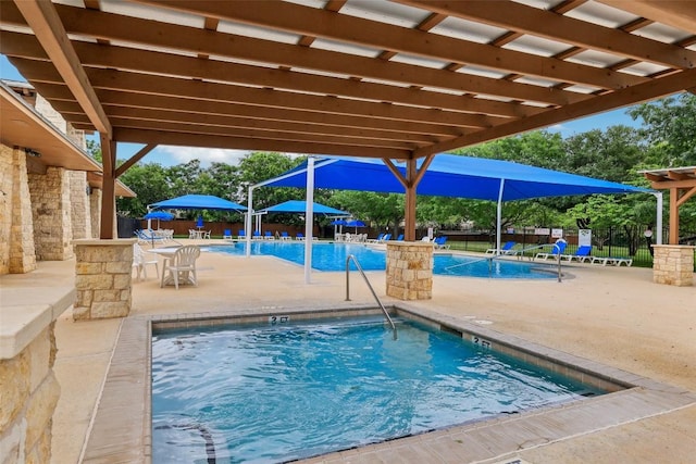 community pool featuring fence and a patio area