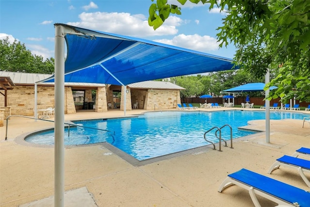 pool featuring fence and a patio area