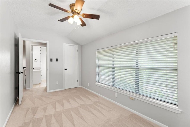 3910 Wendy Oaks Dr, Temple, TX 76502 - unfurnished bedroom with light carpet, lofted ceiling, ceiling fan, and a textured ceiling