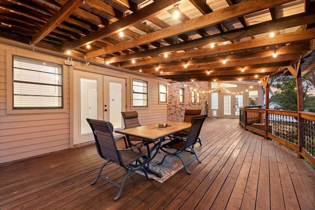 deck with french doors and outdoor dining space