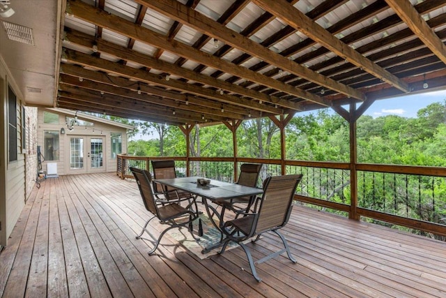 wooden terrace featuring french doors and outdoor dining space