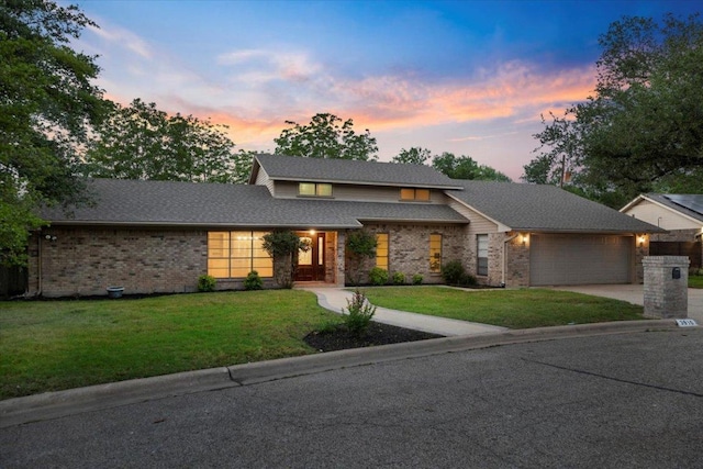 3910 Wendy Oaks Dr, Temple, TX 76502 - view of front of home with a garage, a front lawn, driveway, brick siding, and roof with shingles