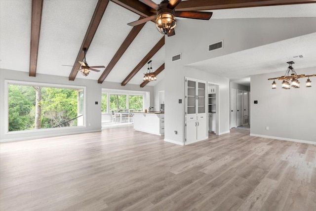 3910 Wendy Oaks Dr, Temple, TX 76502 - unfurnished living room with a chandelier, a ceiling fan, beamed ceiling, high vaulted ceiling, and light wood finished floors