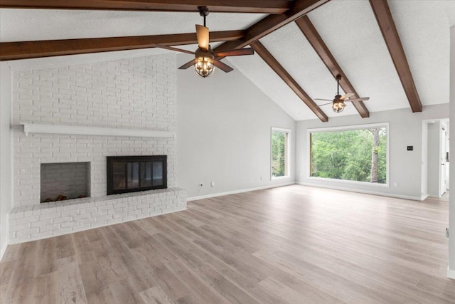 unfurnished living room with a ceiling fan and beam ceiling