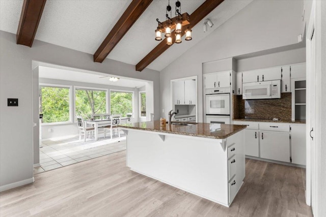 3910 Wendy Oaks Dr, Temple, TX 76502 - kitchen featuring white appliances, beam ceiling, white cabinetry, dark stone countertops, and decorative backsplash