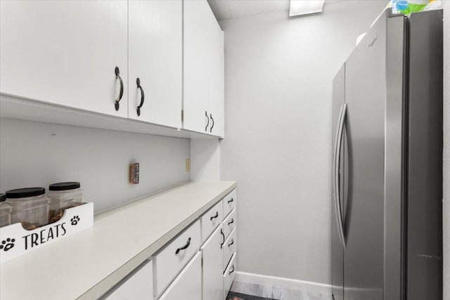 3910 Wendy Oaks Dr, Temple, TX 76502 - kitchen featuring freestanding refrigerator, light countertops, and white cabinets